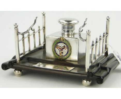 A Chinese silver inkwell on hardwood stand,
with enamel plaque "Shanghai Fire Brigade 1865," width 17cm.