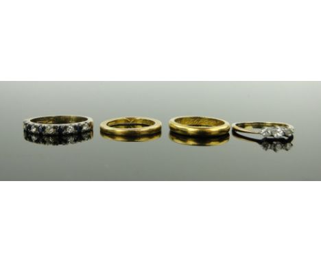 4 various rings,
comprising 2 22ct gold band rings, (7g total), 18ct 3 stone diamond ring and a sapphire and diamond half ete