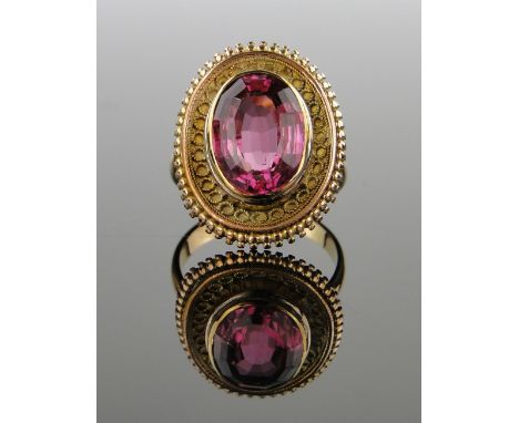 A Continental tourmaline set ring in filigree surround,
unmarked gold settings, setting height 22mm, size K.