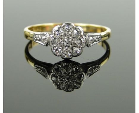 18ct gold and platinum diamond cluster ring,
setting height 8mm, size Q.