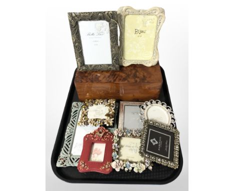 A group of modern photograph frames and a birds eye maple trinket box.