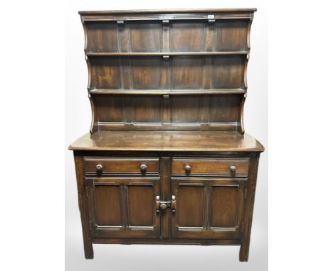 An Ercol stained elm dresser, 122cm w x 47cm d x 167cm h. 