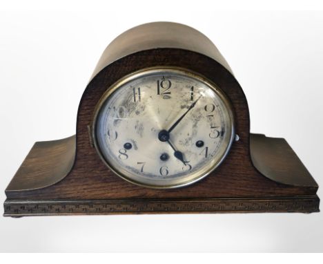 An early-20th century oak eight day mantel clock with silvered dial, width 42cm.