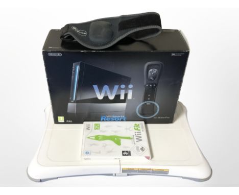 A Nintendo Wii console in box, Wii Fit board, and game.