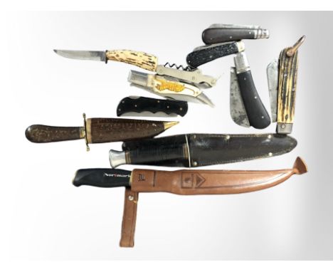 A group of folding pocket knives, two hunting knives in sheaths, etc. 