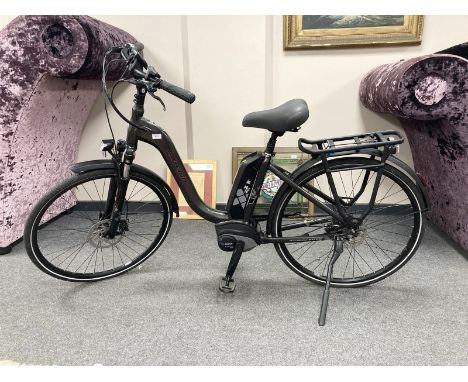 A Raleigh Motus Grand Tour electric bike, with two keys, bosch charger, instruction manual, unused high pressure pump and an 