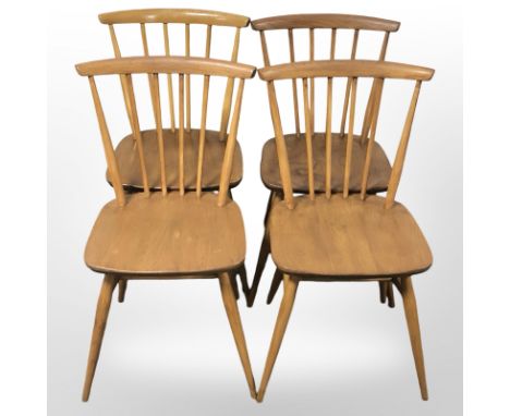 A set of four Ercol stained elm and beech spindle back dining chairs. 