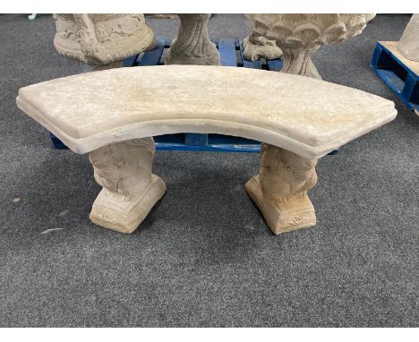 A concrete curved garden bench on squirrel supports, width 103cm. 