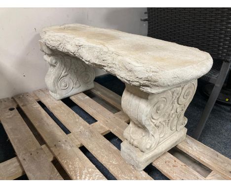 A concrete rustic garden bench on classical supports, width 99cm. 