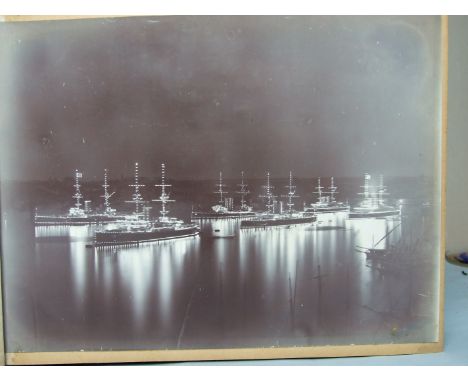 An album of approximately 60 photographs c1900, including five of battleships, two signed 'R Ellis' and 'Symmonds & Co. Ports