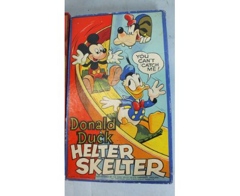 A Chad Valley Donald Duck "Helter Skelter" game, boxed, (box af) and two other games.