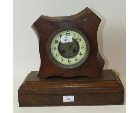 A striking mantel clock movement enclosed in a hardwood propeller boss, mounted on a rectangular oak stand, 38cm high overall