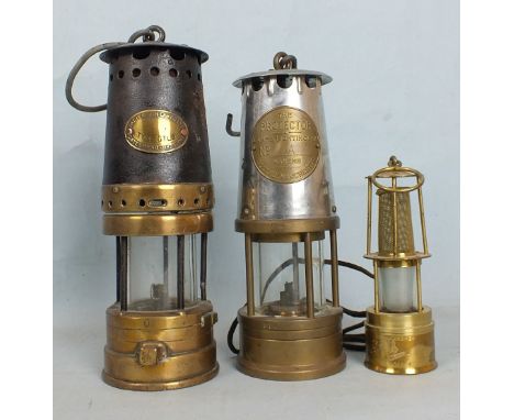 A Patterson Lamps Ltd type GTL9 miner's lamp, a Lamp & Lighting Co. Ltd 'The Protector' miner's lamp and a small electric-pow