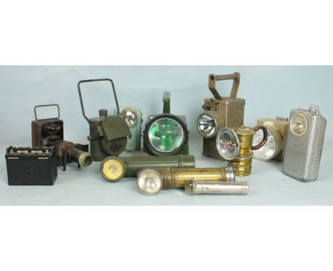 An army signalling lamp, an army bicycle lamp with black-out and other lamps and torches.