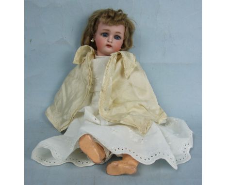 A Kammer & Reinhardt '39' bisque head doll with sleeping blue eyes, blonde wig, open mouth with upper teeth and jointed compo