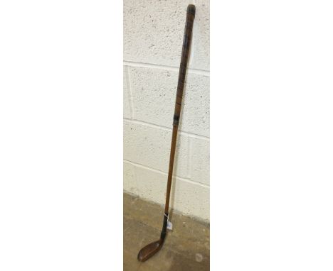 A wooden-headed hickory shaft putter stamped 'R Forgan', with leather-bound grip, 89cm long.
