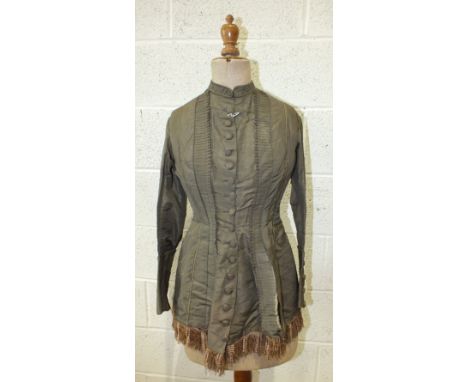 A Victorian ladies day dress jacket c1870's of brown silk with buttoned front, piped seams and pleated and button trimming.