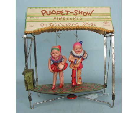 A Japanese CK trademark 'Puppet-Show' tinplate and celluloid clockwork toy c1930's, the card roof printed 'Puppet-Show, Pinoc