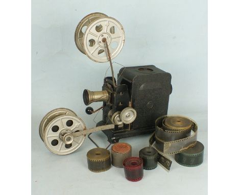 An early 20th century Japanned tin plate projector, hand cranked with seven 34mm films.