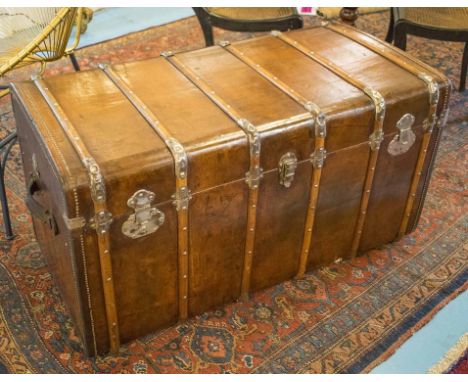 VINTAGE TRAVELLING TRUNK, early 20th century studded and slatted hide leather with rising lid and carrying handles, 115cm x 6