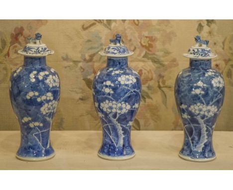 VASES, a set of three, blue and white Chinese ceramic each with 'Dog of foo' lids, 27cm H. (3) (with faults)