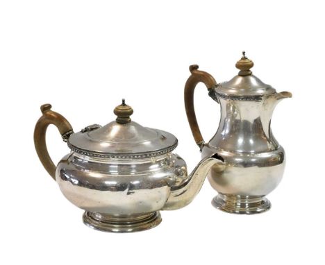 A George V silver teapot &amp; hot water jug, mark of Mappin &amp; Webb, London 1933, the teapot of circular, somewhat balust