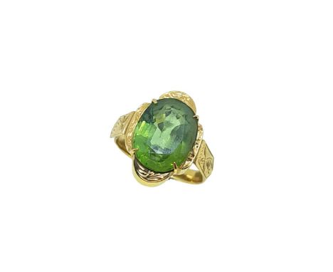 A single stone peridot ring, claw set oval faceted peridot, approximately 12.4 x 9.7 x 5.95mm, estimated approximate weight 5