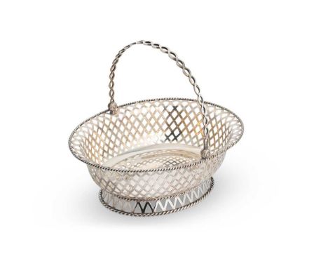 A George V silver swing handled bread basket, mark of Mappin &amp; Webb, London 1918, of oval form, the sides of pierced latt