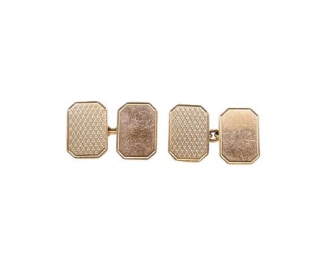 A pair of 9ct gold cufflinks, rectangular panels with truncated corners, one with an engine turned finish and one plain polis
