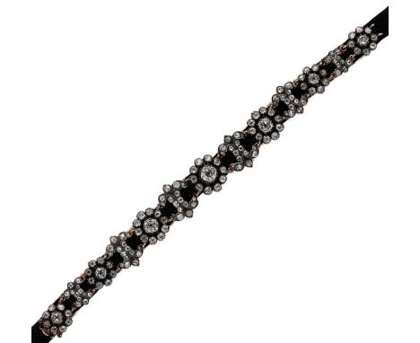 A diamond set velvet choker necklace, seven diamond set floral clusters, each with a central old mine cut diamond within a cu