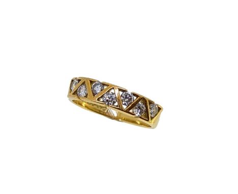 An 18ct gold seven stone diamond ring, each round brilliant cut diamond is within a triangular tension setting, estimated app
