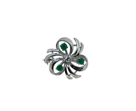 An emerald and diamond floral brooch. central claw set round brilliant cut diamond, estimated approximate weight 0.15ct, furt