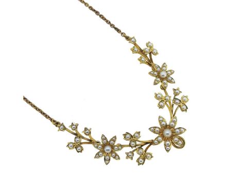 A split pearl necklace, graduated floral centrepiece, set with split pearls, verso, a vacant hook on the central flower, belc