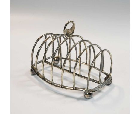 A Victorian silver 7 bar toast rack, mark of John Samuel Hunt, London 1864, simple wire bars to a barrel shaped border, crest