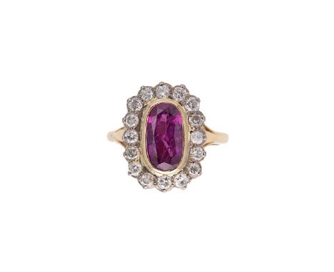 A ruby and diamond cluster ring, rubover set oval faceted ruby, 11.4 x 6.1 x 4.8mm, surrounded by sixteen claw set round bril