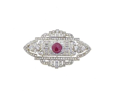 A ruby and diamond panel brooch, geometric style with a central sugarloaf cabochon ruby, approximate diameter 10mm, surrounde