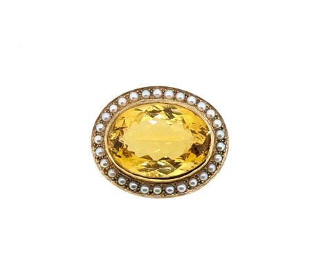 A citrine and pearl target style brooch, rubover set oval faceted citrine, approximately 30 x 22mm, surrounded by a border of