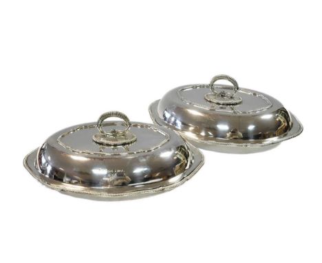 A pair of George V silver entrée dishes, mark of Reid &amp; Sons, Sheffield 1933, of oval form, bases and covers both with ga