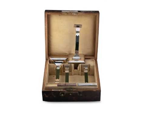 A set of four Edward VII silver and nephrite candlesticks in a fitted travelling case, mark of Frank Hyams Ltd., London 1909,