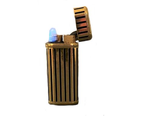 Cartier - A 'Les Must de Cartier' gold plated and enamel pocket cigarette lighter, circa 1985, of rectangular form with round