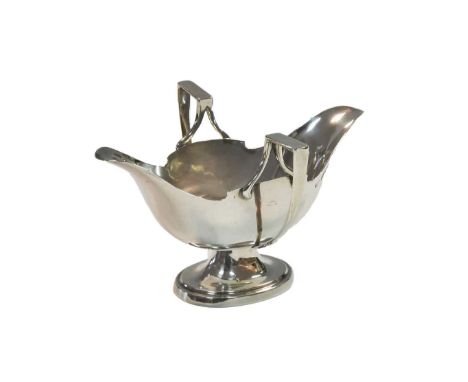 A George V silver sauce boat of unusual design, mark of Mappin &amp; Webb, London 1914, with double spout and two angular han