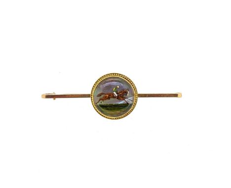 A reverse painted crystal intaglio brooch, depicting a jockey on a galloping racehorse, mounted to a flat bar, pin and hook f