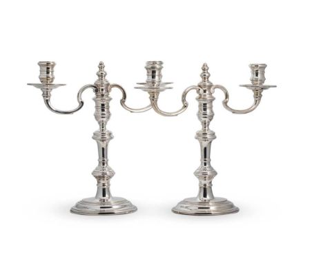 A pair of Elizabeth II silver two light metamorphic candelabra, mark of William Comyns &amp; Sons Ltd., (Richard Comyns), Lon