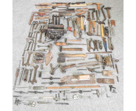A collection of vintage hand tools, together with a vice