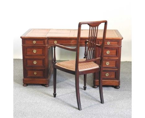 A Victorian mahogany inverted breakfront pedestal desk, bearing a label for Kerridges of Hailsham, with an inset writing surf