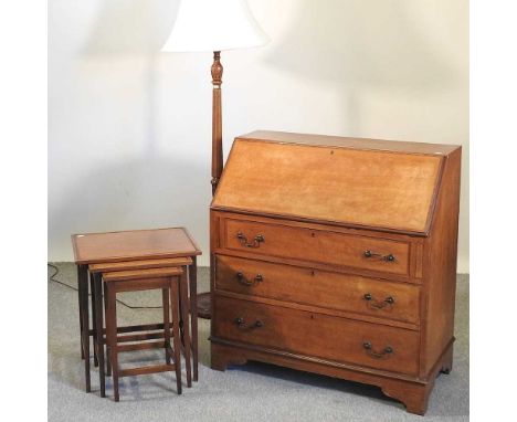 An Edwardian mahogany and cross banded bureau, together with a standard lamp and a nest of occasional tables (3)