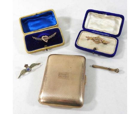 An early 20th century gold plated cigarette case, 8cm wide, together with a 9 carat gold and enamelled RAF brooch, a 15 carat