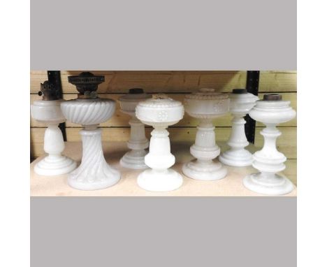 A collection of seven various 19th century milk glass lamp bases, highest 34cm