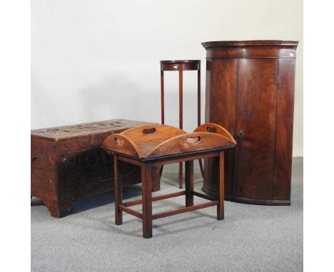 An early 20th century carved camphor wood trunk, 91cm, together with a George III bow front hanging corner cabinet, an Edward