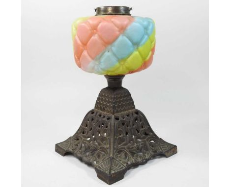 An Art Deco oil lamp, with a rainbow coloured glass font, 28cm highCondition report: Glass font appears to be complete with n